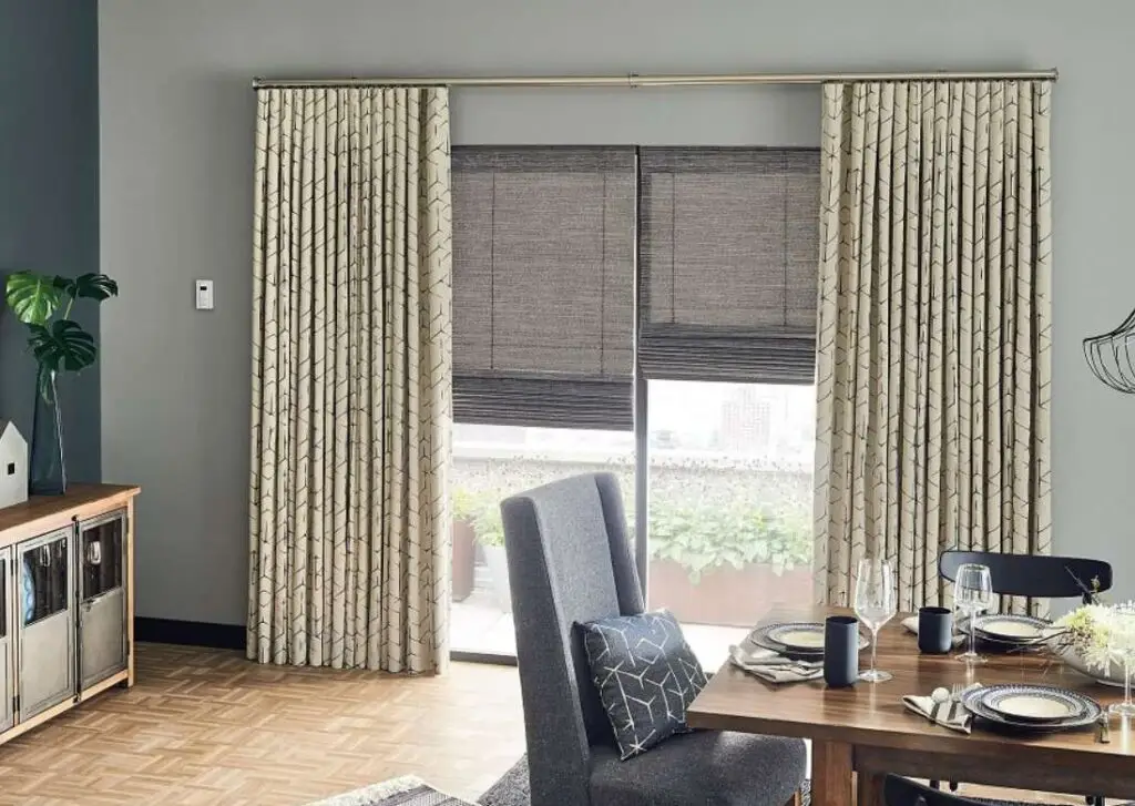 Chic living room with patterned curtains over neutral color shades Energy-efficient